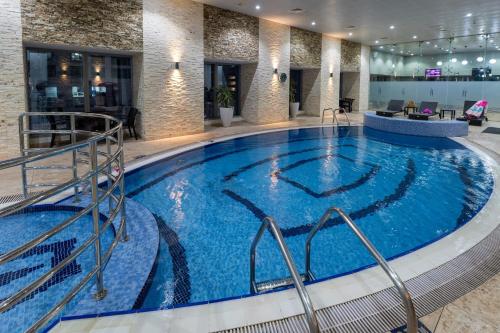 a large swimming pool in a hotel lobby at Veer Apartments - 87th Floor Penthouse Full Sea View 5 BHK in Dubai