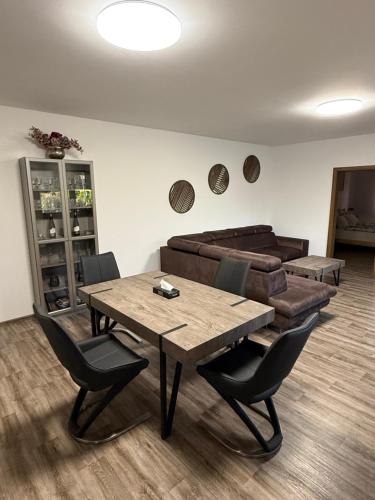 a dining room with a table and a couch at Apartmán Leona in Humpolec