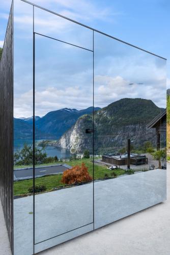 a glass house with a view of the mountains at Lingåsen Panorama! in Valldal