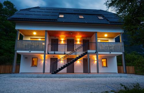 a house with a staircase in front of it at House Elipsa in Bovec