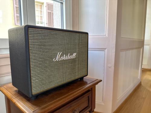 a television sitting on top of a wooden table at B&B Brig by KaffeeKlatsch in Brig
