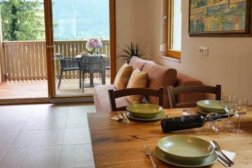 a dining room with a wooden table with plates on it at House Elipsa in Bovec