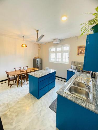 a kitchen and dining room with a sink and a table at SAN Holiday in Wadduwa