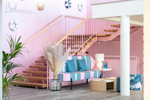 a room with a chair and a pink staircase at Belambra Clubs Capbreton - Les Vignes in Capbreton