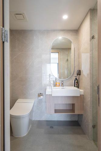 a bathroom with a sink and a toilet and a mirror at Studio-GH5 - Vinhomes Grand Park - Thu Duc City in Long Bình