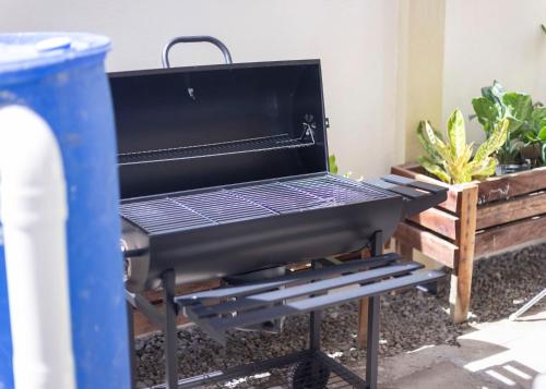 a barbecue grill in a backyard with plants at Holiday Home in Dauis, Panglao Island Bohol in Dauis