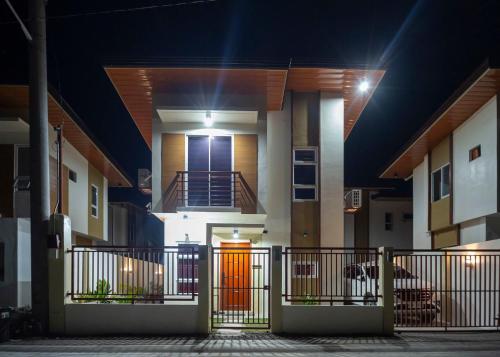 a house with an orange door at night at Holiday Home in Dauis, Panglao Island Bohol in Dauis