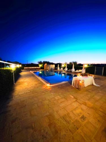 a swimming pool at night with a sky background at Trulli Nuova Aia Resort in Alberobello