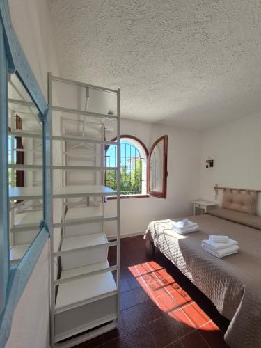 a room with a ladder next to a bed at La Terrazza sull'Alba in Costa Rei