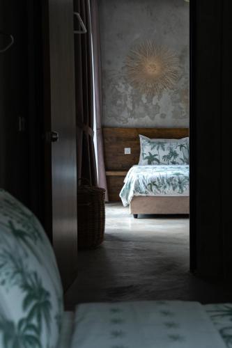 a bedroom with a bed with a painting on the wall at Chrisenbel Hideaway Retreat in Petaling Jaya