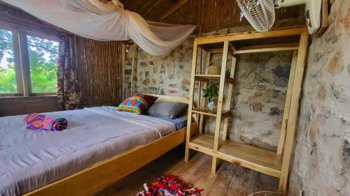 a bedroom with a bunk bed in a cabin at Butterfly Space- A Non-Profit Eco-Lodge in Nkhata Bay
