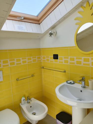a bathroom with a sink and a mirror at La Fuga Affittacamere in Monticello d'Alba