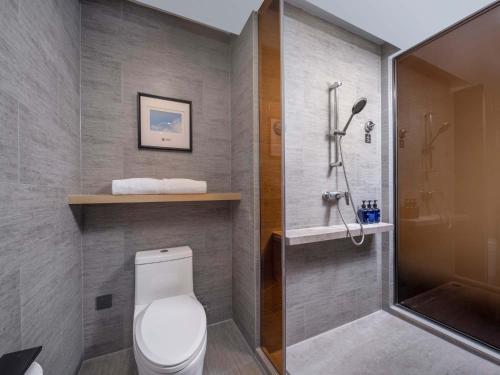 a bathroom with a toilet and a shower at Holiday Inn Express Zhuhai Grand Theater by IHG in Zhuhai