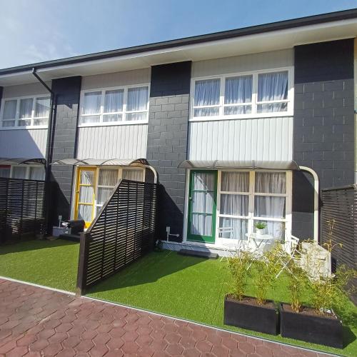 a house with a green lawn in front of it at City Central in Nelson