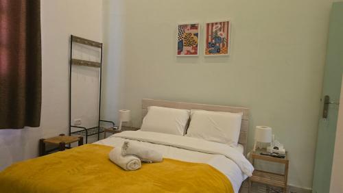 a bedroom with a bed with towels on it at Al Bishara Guest House in Nazareth