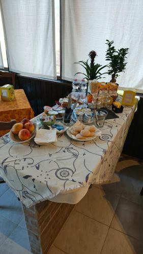 a table with plates of food on it at Tidale Host house B&B in Alghero