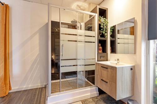 a bathroom with a shower and a sink at The marine apartment near Amsterdam by Weltevreden Experience in Kortenhoef