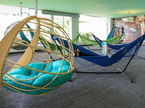 two hammocks in a room withacers at ibis Styles Ribeirao Preto Maurilio Biagi in Ribeirão Preto