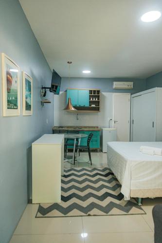 a bedroom with a bed and a table and a kitchen at Pecem Beach Hotel - Aval Hotel in Pecém