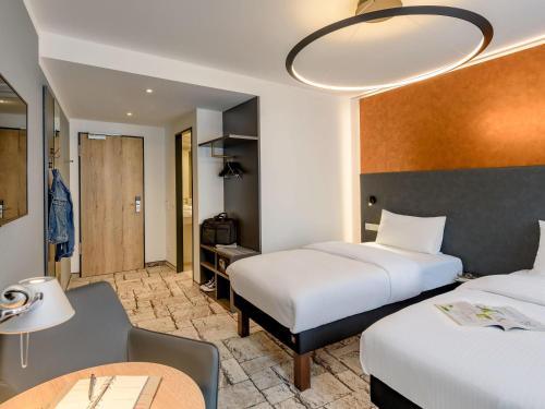 Postel nebo postele na pokoji v ubytování ibis Styles Bamberg