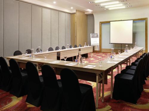 a large conference room with a long table and chairs at Mercure Bandung Nexa Supratman in Bandung