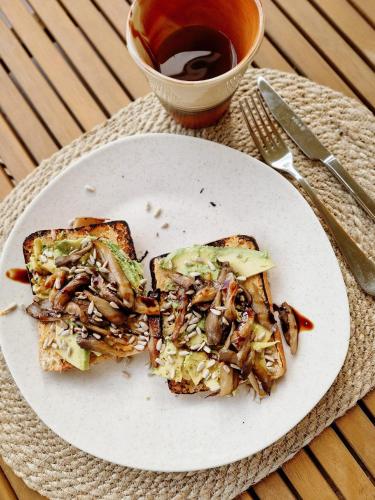 a white plate with two slices of bread with mushrooms at RetreatHouse in Lith