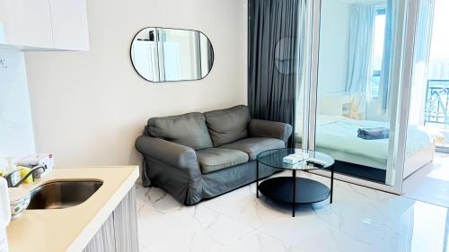 a living room with a couch and a table at Artisan Ratchada Condo Bangkok in Bangkok