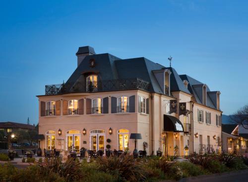 a large white building with a black roof at Enchante Boutique Hotel in Los Altos