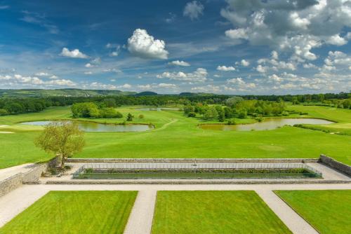 an aerial view of a golf course with a pond at Hôtel Golf Château de Chailly in Chailly-sur-Armançon