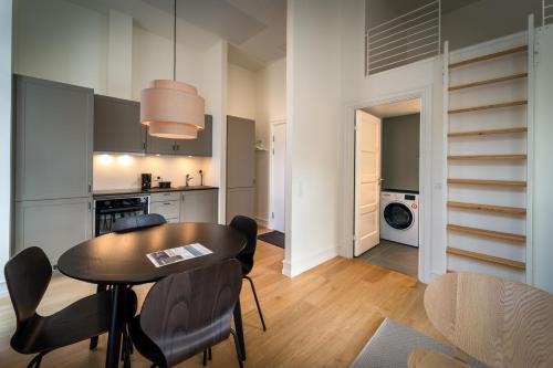 a kitchen and dining room with a table and chairs at Hotel Lille Nyhavn in Skanderborg