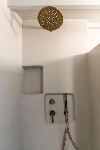 a bathroom with a light on the ceiling at Aelios Cycladic house in Nisída Planítis
