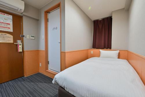 Postel nebo postele na pokoji v ubytování Central Hotel Sasebo