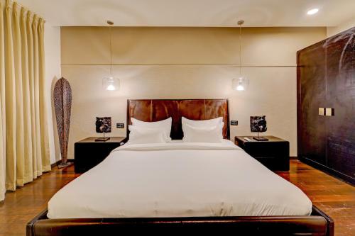 a bedroom with a large bed and two night stands at HOTEL THE SLATE Near APOLLO HOSPITAL & US EMBASSY in Chennai