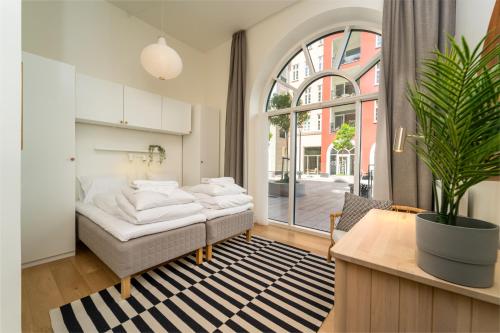 a bedroom with a bed and a large window at Hotel Lille Nyhavn in Skanderborg