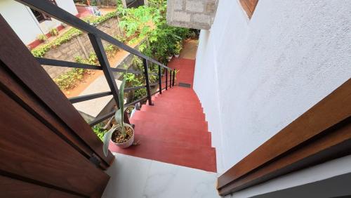 an overhead view of a staircase with a red floor at Wilthera in Anuradhapura
