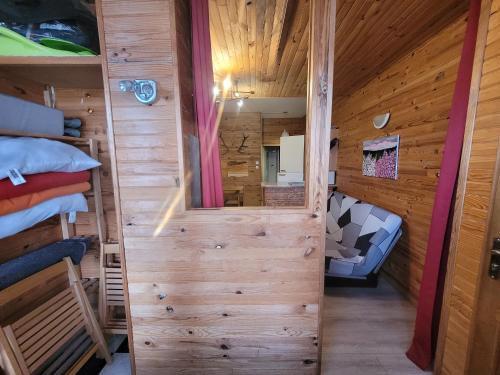 a room with a wooden cabin with a bunk bed at Appartement Pyrénées 2000 in Bolquere Pyrenees 2000