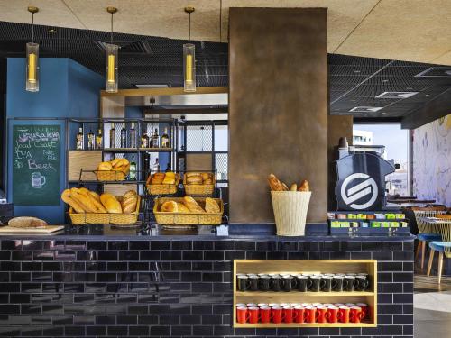 a bakery with lots of bread and baskets of food at Ibis Styles Jerusalem City Center - An AccorHotels Brand in Jerusalem