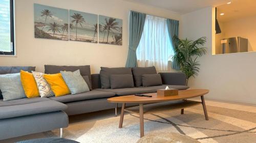a living room with a couch and a coffee table at Casa Stella 1 Aquarius by Liaison in Osaka