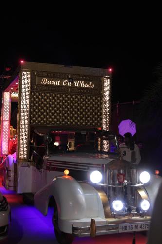 an old truck is on display at night at Hotel Wedcaton By Tivoli - Ambala in Ambāla