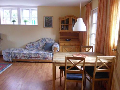 a living room with a couch and a table at Haus In Zimmert Mit Terrasse, Grill Und Garten in Rieseby