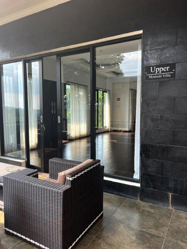 a lobby with a couch in front of a building at Moment Villa in Lembang
