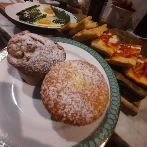 two donuts on a plate with bread and eggs at Pane e Marmellata in Signa