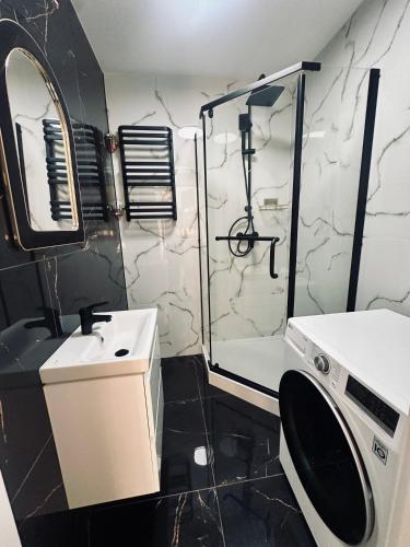 a bathroom with a shower and a sink and a toilet at Apartament in Tarnowskie Góry