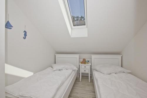 Ένα ή περισσότερα κρεβάτια σε δωμάτιο στο moderne Ferienwohnung mit Balkon, Meerblick - Ferienresidenz Zwei BoddenFeWo 1-5
