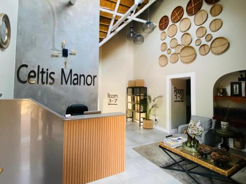 a lobby of a store with a celtis manor sign on the wall at Celtis Manor Guesthouse in Midrand