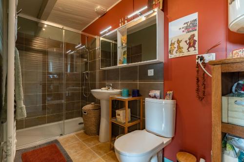 a bathroom with a toilet and a shower and a sink at La Casita in Beauvène