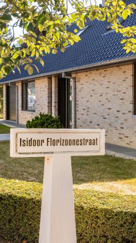 a sign in front of a building with a house at Villa Maurice close to the beach in Oostduinkerke