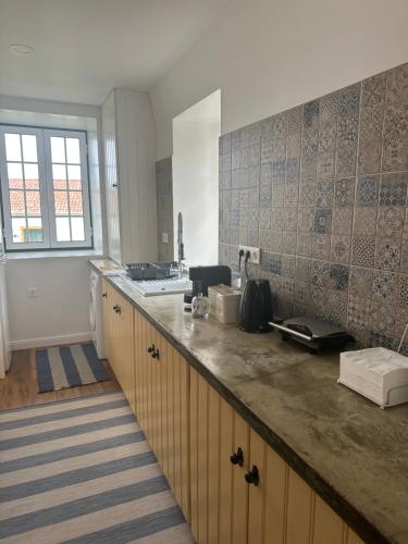a kitchen with a counter top and a sink at Solar Nossa Senhora da Conceição in Capelas