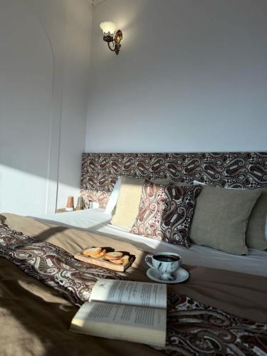a bed with a table with a plate of food on it at Nazaara - Mukteshwar - Mountain view and sunset from your bed in Mukteswar