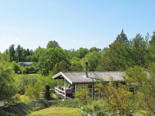 a house in the middle of a garden at 4 person holiday home in Højslev in Højslev